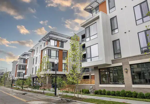 Park Morton, a contemporary apartment complex with modern design, large windows, and landscaped surroundings.