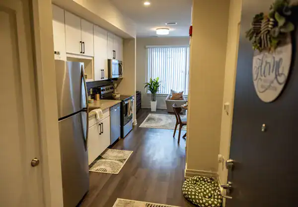 Park Morton unit entry with modern kitchen and stylish decor and ample natural light.