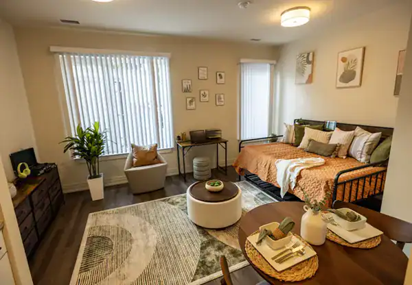 Modern bedroom suite with stylish decor and ample natural light at Dantes Partners.